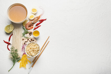 Obraz na płótnie Canvas Bowl of tasty Thai soup and ingredients on light background