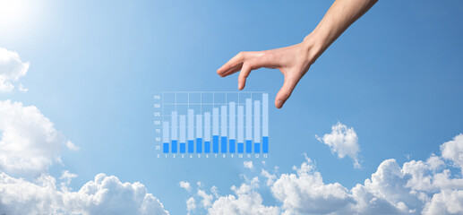 Business man holding tablet and showing holographic graphs and stock market statistics gain profits. Concept of growth planning and business strategy. Display of good economy form digital screen.