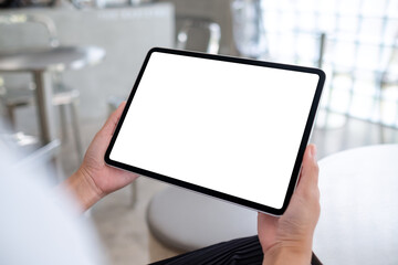 Mockup image of a woman holding digital tablet with blank white desktop screen