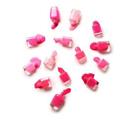 Overturned bottles of nail polishes on white background