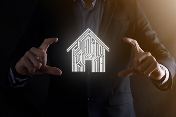 Businessman hold house icon.Smart home controlled, intelligent house, and home automation app...