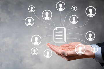 Man hold document and user icon.Corporate data management system DMS and document management system concept. Businessman click or publish on document connected with corporate users