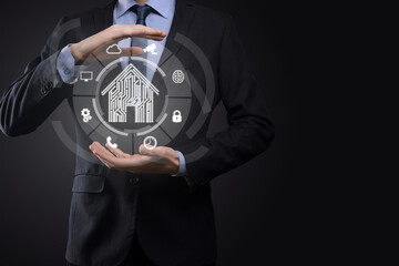 Businessman hold house icon.Smart home controlled, intelligent house, and home automation app concept.Pcb design and person with smart phone. Innovation technology internet Network Concept.