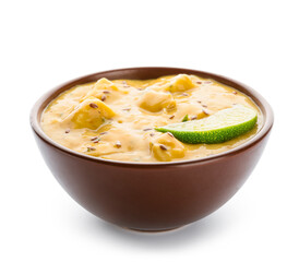 Bowl of tasty chicken curry on white background