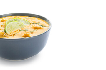 Bowl of tasty chicken curry on white background
