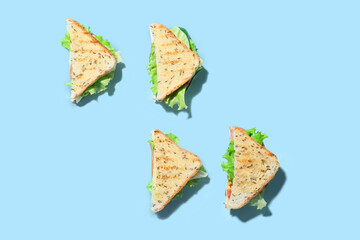 Tasty sandwiches on color background