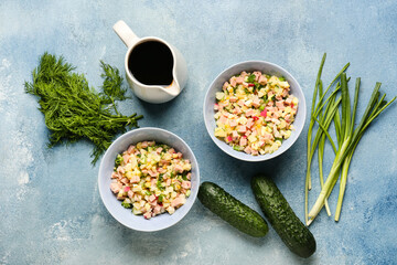 Bowls with different ingredients for okroshka on color background