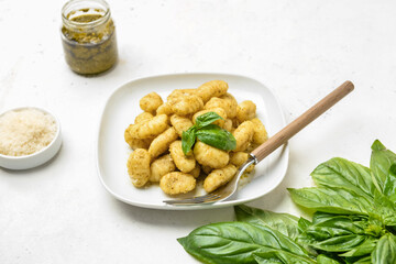 Plate with tasty pesto gnocchi on table