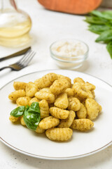 Plate with tasty pesto gnocchi on table