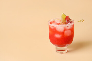 Glass of tasty strawberry margarita on color background