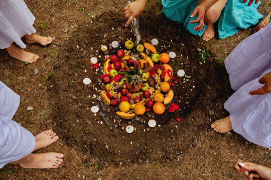 Female Friends Around Fruits In Pit Performing Temazcal Ritual