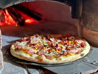 Special wood-fired pizza oven. Cook using a special shovel.