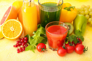 Glasses with healthy juice, fruits and vegetables on color background