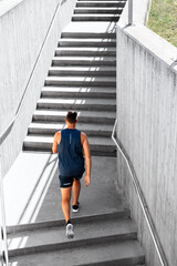 fitness, sport and healthy lifestyle concept - young man running upstairs