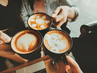 Group of people working and drinking hot coffee with latte art in the cafe.