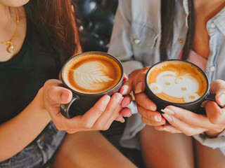 Group of people working and drinking hot coffee with latte art in the cafe.