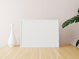 White horizontal frame mockup on wooden table with vase and plants. 3d rendering.