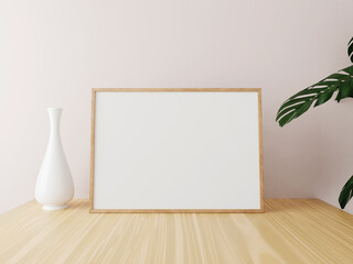 Horizontal wooden frame mockup on wooden table with vase and plants. 3d rendering.