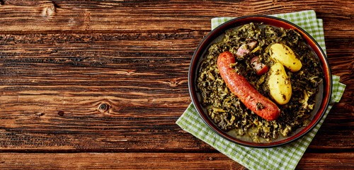Fresh braised or boiled kale with spicy German sausage