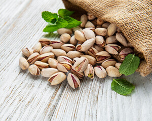 Sack with pistachios on a wooden table