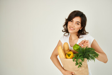 Woman in white t-shirt package with groceries healthy food delivery supermarket