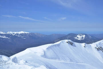 Fototapeta na wymiar Panorama of Snow Mountain Range Landscape with Blue Sky from russia sochi