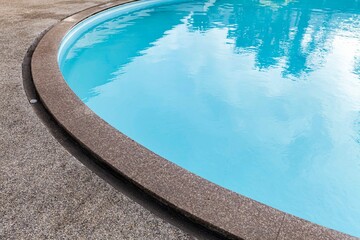 Obraz na płótnie Canvas Wide swimming pool and brown stone floor inside the villa