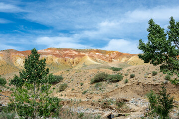 mountain peaks in mountain altai and blue sky with clouds