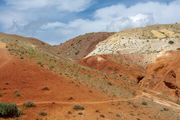 rocks made of colored clay against the backdrop of a beautiful blue sky