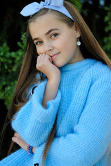 beautiful teenage girl with long hair wearing blue glasses and a plaid shirt portrait