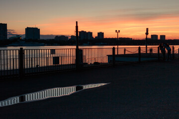 Moscow River embankment at sunset. Puddles on the embankmen