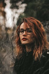 girl in a black short dress on the evening street. against the backdrop of lights, shops.