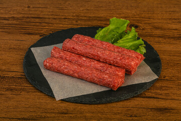 Raw beef sausages with spices