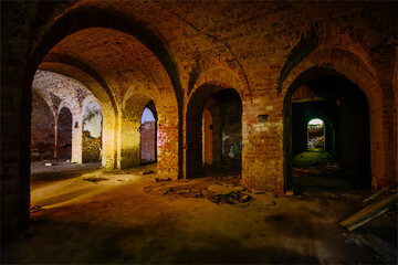 Vaulted red brick dungeon under old mansion