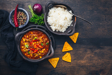 Bowl of chili con carne with rice and toppings