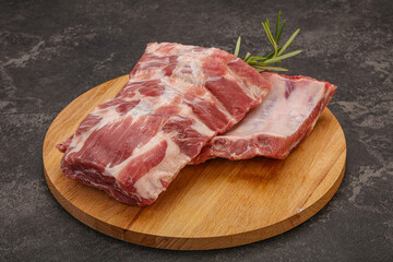 Raw pork ribs served rosemary