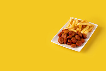 Traditional German currywurst on yellow background. Copy space