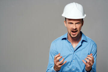 Cheerful male engineer in white construction helmet professional working