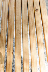 A wooden chair on the street. close-up of the boards. Pine forest. Rest with the whole family in the country, fun trips in the fresh air. Rest on a picnic at a camping site.