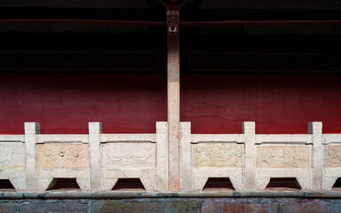 stone fence in front of red walls