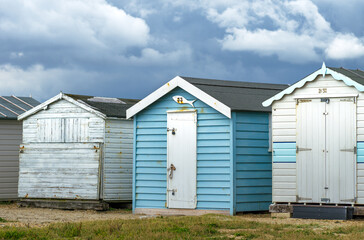Fototapeta na wymiar Blue and White Shed or Beach Huts Near the Seaside of Portsmouth, England