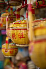 Some empty Chinese bamboo baskets in closeup. Translation on the text is "getting prosperous together".