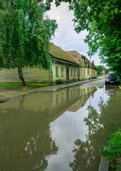 Street with big water puddle.