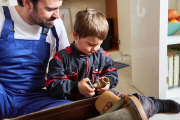 Father and son as handyman with shut-off valve