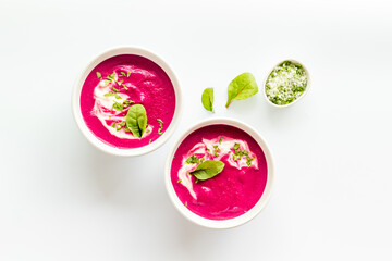 Cream soup made of red beet roots with basil