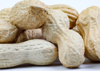Peanuts in shell and on a white background.