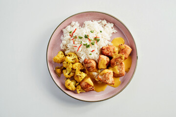 Hot spicy chicken curry with basmati rice and cauliflower