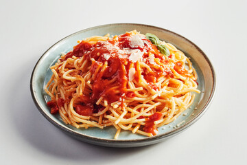 Italian spaghetti pasta topped with tomato sauce and cheese