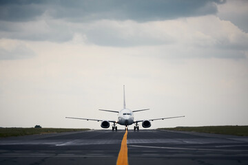 Front view of plane at airport. Commercial airplane during taxiing to runway for take off.