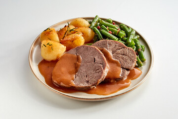 Delicious tender medallions of roasted beef with vegetables